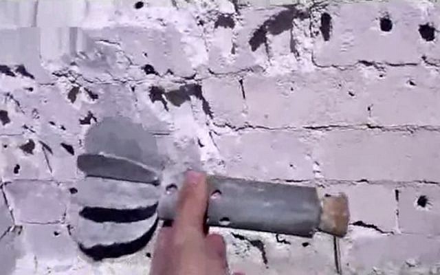 This image made from amateur video released by Shaam News Network purports to show rocket fins and shrapnel damage after overnight fighting in Damascus (photo credit: AP/Shaam News Network via AP video) This image made from amateur video released by Shaam News Network purports to show rocket fins and shrapnel damage after overnight fighting in Damascus (photo credit: AP/Shaam News Network via AP video)