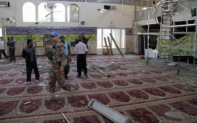 UN observers in a suburb of Damascus inspect the prayer hall of the Sayyida Zeinab shrine after it was damaged by a car bomb on Thursday. (photo credit: Bassem Tellawi/AP)