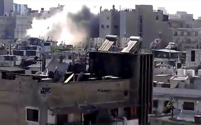 This image made from amateur video released by Shaam News Network shows shelling in Joret el-Shayah, Homs, Syria. (photo credit: AP/Shaam News Network) This image made from amateur video released by Shaam News Network shows shelling in Joret el-Shayah, Homs, Syria. (photo credit: AP/Shaam News Network)