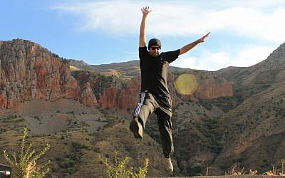 Mykil Bachoian jumps for joy in Armenia. He’s also explored his roots in Israel. (photo credit: Courtesy/JTA)