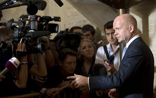 British Foreign Minister William Hague, right, talks to media representatives upon his arrival for a meeting of the Action Group for Syria at the European headquarters of the United Nations. (photo credit: AP)
