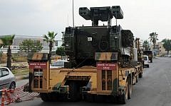A Turkish military truck transports a mobile missile launcher to the Syrian border, in Iskenderun, Turkey, on Wednesday.  (photo credit: AP Photo)