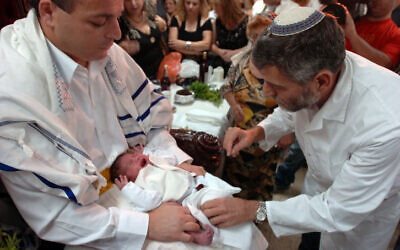 A rabbi performs a circumcision on an 8-day-old Jewish boy (illustrative photo: Max Yelinson/Flash90)