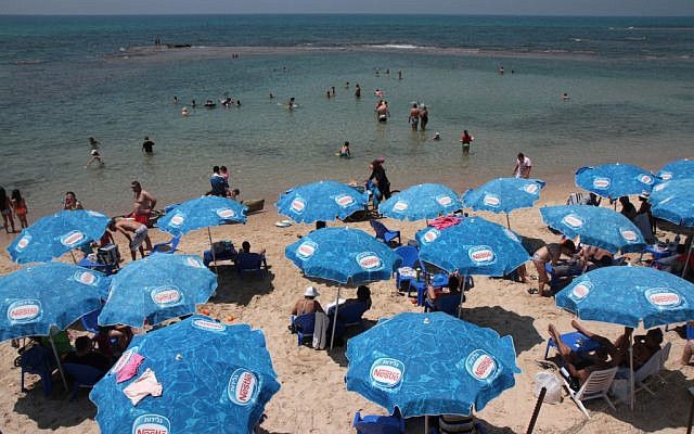 Beach goers at the seashore in Bat Yam (photo credit: Alana Perino/Flash90)
