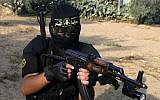 A masked fighter from Islamic Jihad's military wing takes part in a military drill in the southern Gaza Strip in May 2012. (photo credit: Abed Rahim Khatib/Flash90)