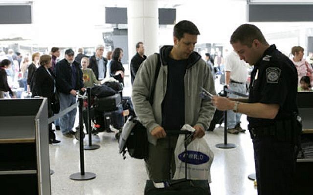 Illustrative photo of a customs officer checking a passenger's passport at Washington-Dulles International Airport. (James Tourtellotte/Department of Homeland Security) Illustrative photo of a customs officer checking a passenger's passport at Washington-Dulles International Airport. (James Tourtellotte/Department of Homeland Security)