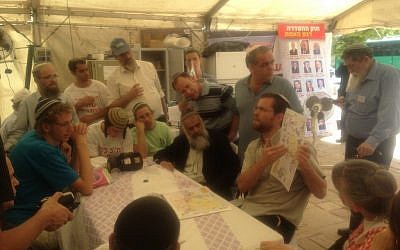 Hanan Hexter of the Givat Asaf outpost showing the facts as they appear on the maps (Photo credit: Mitch Ginsburg)