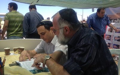 Two residents of Psagot study Talmud before the Knesset vote (Photo credit: Mitch Ginsburg/ Times of Israel)
