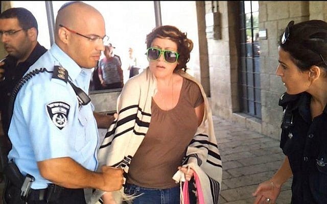 Illustrative photo of a  woman being detained at the Western Wall in 2012 (photo credit: Courtesy Women of the Wall via Facebook)