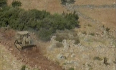 An IDF bulldozer works on the Golan Heights on Thursday (photo credit: Channel 10)