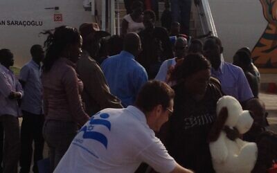 An Israid worker greets deportees from Israel. (photo credit: courtesy)