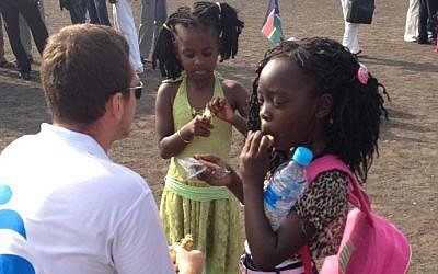 An IsraAid worker with Sudanese children. (photo credit: courtesy)