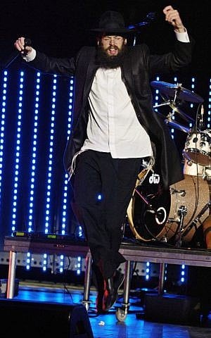 Matisyahu dances during his set at a summer concert in Irvine, Calif., in this May 2006, file photo. (photo credit: AP Photo/Chris Pizzello/FILE)