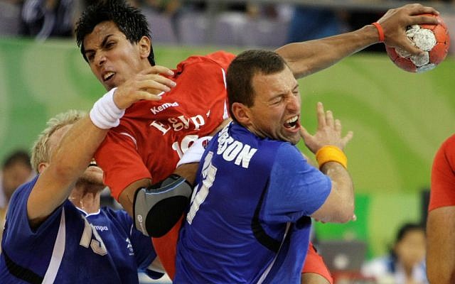 Egypt's Abouelfetoh Abdelrazek, center, fights for a ball against Iceland's Alexander Petersson, left, and Sverre Andreas Jakobsson during their men's handball preliminary match at the Beijing 2008 Olympics (photo credit: AP/Lee Jin-man)