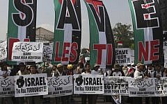 Muslim activists hold pro-Palestinian and anti-Israeli placards at a rally in Jakarta, Indonesia, in June 2010, days after the Mavi Marmara flotilla incident. (photo credit: AP/Achmad Ibrahim)