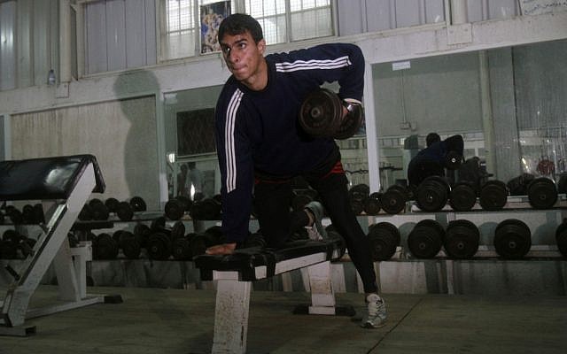 Palestinian athlete Baha Alfarra, who will compete the 400-meter Olympic race trains at a gym in Gaza City in March 2012 (photo credit: AP/Adel Hana) Palestinian athlete Baha Alfarra, who will compete the 400-meter Olympic race trains at a gym in Gaza City in March 2012 (photo credit: AP/Adel Hana)