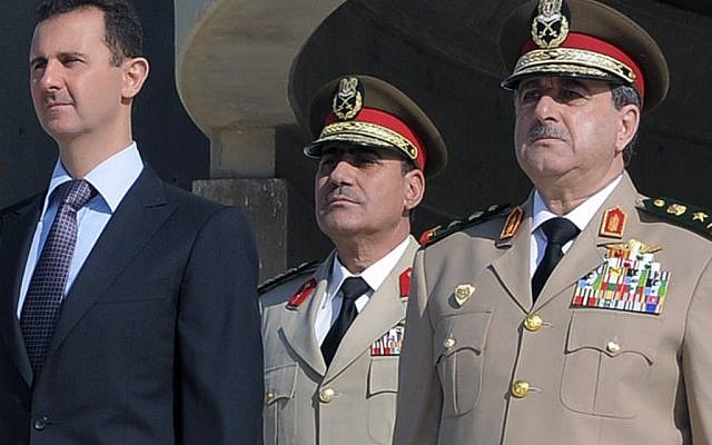 Syrian President Bashar Assad and his defense minister Dawoud Rajha (right) at a memorial ceremony for the 1973 War, October 2011 (photo credit: AP Photo/Sana) Syrian President Bashar Assad and his defense minister Dawoud Rajha (right) at a memorial ceremony for the 1973 War, October 2011 (photo credit: AP Photo/Sana)