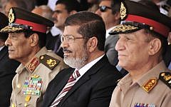 Egyptian Field Marshal Gen. Hussein Tantawi (left) and Egyptian President Mohammed Morsi (center) attend a medal ceremony at a military base east of Cairo (photo credit: Mohammed Abd El Moaty, Egyptian Presidency/AP)