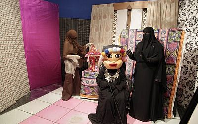 Heba Seraj, left, Shaimaa Hamid, center, and Shaimaa Abdelhamid, right, prepare to film a segment of a Ramadan program at the Maria TV channel's studio in Cairo on Monday, July 23, 2012. (photo credit: Maya Alleruzzo/AP)