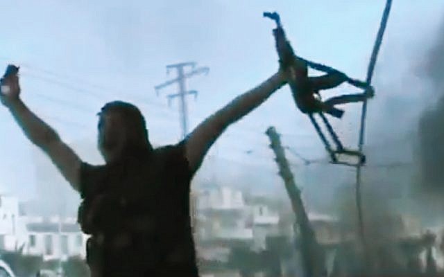 In this image made from amateur video released by the Ugarit News and accessed Monday, July 23, 2012, a Free Syrian Army soldier reacts during clashes with Syrian government troops in Aleppo, Syria. The Syrian regime acknowledged for the first time Monday that it possessed stockpiles of chemical and biological weapons and said it will only use them in case of a foreign attack and never internally against its own citizens. (photo credit: AP/Ugarit News via AP video) In this image made from amateur video released by the Ugarit News and accessed Monday, July 23, 2012, a Free Syrian Army soldier reacts during clashes with Syrian government troops in Aleppo, Syria. The Syrian regime acknowledged for the first time Monday that it possessed stockpiles of chemical and biological weapons and said it will only use them in case of a foreign attack and never internally against its own citizens. (photo credit: AP/Ugarit News via AP video)