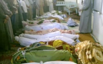 This image, taken from an amateur video, shows the bodies of dozens of victims killed in Tremseh, Syria (some nine miles from Hama) on Thursday. Rebels said the government rained shells on farmers in what they called one of the worst days of bloodshed since the uprising against President Bashar Assad's regime began. (photo credit: Hama Revolution 2011 via AP video)