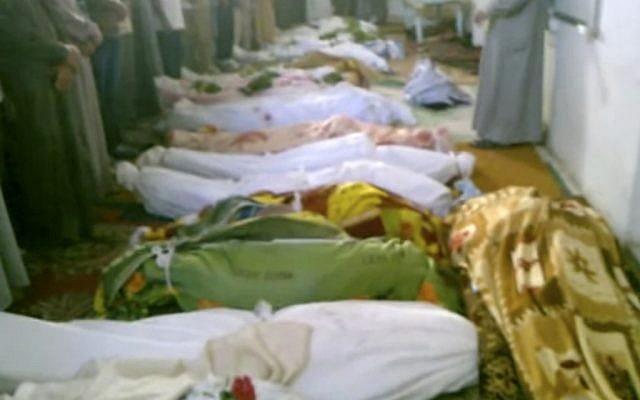 This image made from amateur video from Hama Revolution 2011 and accessed by AP video Friday, July 13, 2012 purports to show bodies of victims killed by violence that, according to anti-regime activists, was carried out by government forces in Tremseh, Syria. (photo credit: AP/Hama Revolution 2011 via AP video) This image made from amateur video from Hama Revolution 2011 and accessed by AP video Friday, July 13, 2012 purports to show bodies of victims killed by violence that, according to anti-regime activists, was carried out by government forces in Tremseh, Syria. (photo credit: AP/Hama Revolution 2011 via AP video)
