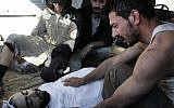 A Syrian man mourns his friend, killed Saturday in Homs (photo credit: AP Photo/Shaam News Network)