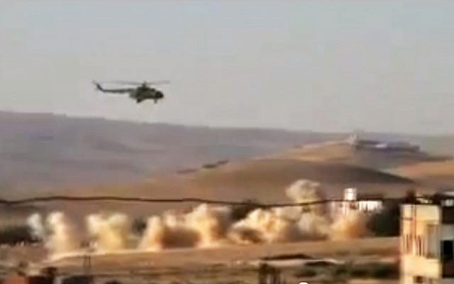A helicopter gunship flies a bombing run in al-Qalmoun, Syria, on Tuesday, July 24, 2012. (photo credit: Shaam News Network, SNN/AP) A helicopter gunship flies a bombing run in al-Qalmoun, Syria, on Tuesday, July 24, 2012. (photo credit: Shaam News Network, SNN/AP)
