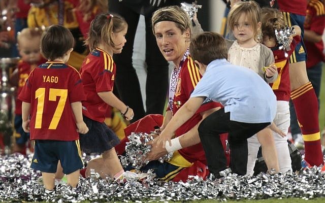 Children brought onto the pitch surround Spain's Fernando Torres after his team's 4-0 victory at the Euro 2012 soccer final on Sunday. (photo credit: AP/Ivan Sekretarev) Children brought onto the pitch surround Spain's Fernando Torres after his team's 4-0 victory at the Euro 2012 soccer final on Sunday. (photo credit: AP/Ivan Sekretarev)