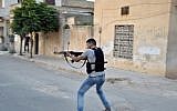 A Syrian rebel fires his weapon at Syrian troops in Idlib, Syria, July 22 (AP Photo/Fadi Zaidan)