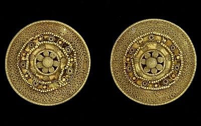 A pair of gold ear studs. 6th century BCE, with granulated discs forming a rosette (photo credit: Courtesy Bible Lands Museum)