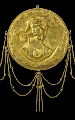 Gold disc pendant with chains, with three-quarter bust of a woman wearing a studded diadem and earrings (photo credit: Courtesy Bible Lands Museum)