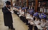 Young ultra-Orthodox boys wearing crowns receive their first prayer books at  a ceremony at the Western Wall, in Jerusalem's Old City, on Tuesday (photo credit: Uri Lenz/Flash90)