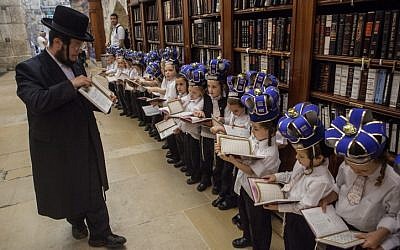 Young ultra-Orthodox boys wearing crowns receive their first prayer books at  a ceremony at the Western Wall, in Jerusalem's Old City, on Tuesday (photo credit: Uri Lenz/Flash90)