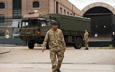 An army vehicle in east London with a few of  the 3,500 troops involved in keeping the 2012 Olympics safe, July 16 (photo credit: Dominic Lipinski/AP)