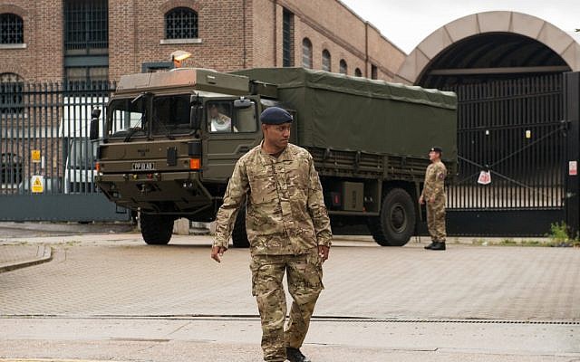 An army vehicle in east London with a few of  the 3,500 troops involved in keeping the 2012 Olympics safe, July 16 (photo credit: Dominic Lipinski/AP)