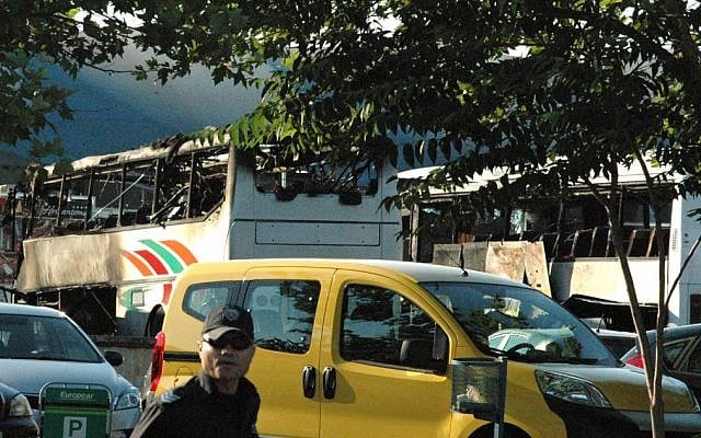 Bulgarian policeman is seen in front of destroyed buses at Burgas Airport, Bulgaria on Wednesday, July 18, 2012 (photo credit: AP/Bulphoto Agency) Bulgarian policeman is seen in front of destroyed buses at Burgas Airport, Bulgaria on Wednesday, July 18, 2012 (photo credit: AP/Bulphoto Agency)