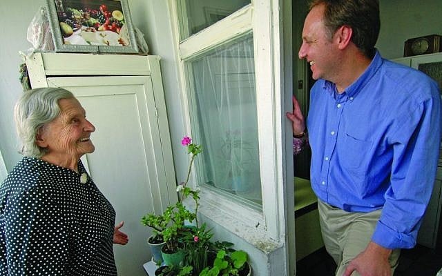 Claims Conference chief Greg Schneider visiting a Nazi victim at her home in Moldova. (Photo credit: Courtesy of Claims Conference/JTA) Claims Conference chief Greg Schneider visiting a Nazi victim at her home in Moldova. (Photo credit: Courtesy of Claims Conference/JTA)