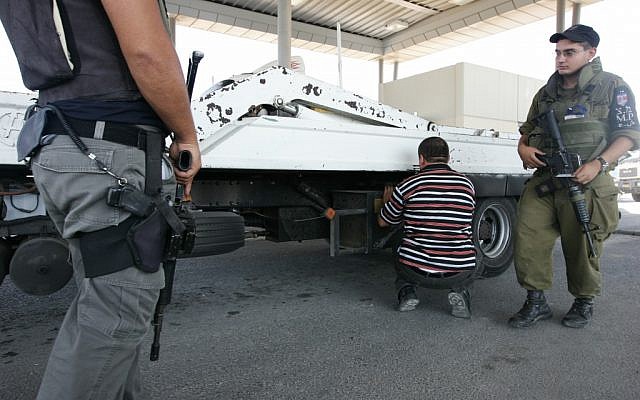 Israeli soldiers check a truck at the Qalandiya checkpoint north of Jerusalem, August 2008. (photo credit: Kobi Gideon/Flash90)