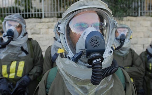 IDF Home Front Command soldiers wearing chemical protection gear participate in a drill simulating a chemical missile attack in July 2009. Sources in Damascus warned that an Israeli strike on Syrian chemical weapons depots will prompt their use in an non-conventional war. (photo credit: Gili Yaari/Flash 90) IDF Home Front Command soldiers wearing chemical protection gear participate in a drill simulating a chemical missile attack in July 2009. Sources in Damascus warned that an Israeli strike on Syrian chemical weapons depots will prompt their use in an non-conventional war. (photo credit: Gili Yaari/Flash 90)