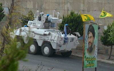Spanish UN troops in southern Lebanon patrol under the Hezbullah flag (Photo credit: Flash 90)