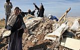 Illustrative: Palestinians try to retrieve items from the rubble of a house after it was destroyed by IDF tractors near the West Bank village of Susya in 2011. (Najeh Hashlamoun/ Flash90)