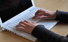 Illustrative image of a woman using a laptop computer. (Sophie Gordon/Flash90)
