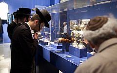 Visitors looking at photographs displayed at the Israel Museum exhibition "A World Apart Next Door: Glimpses into the life of Hasidic Jews" in Jerusalem on June 20, 2012 (photo credit: Yonatan Sindel/Flash90)