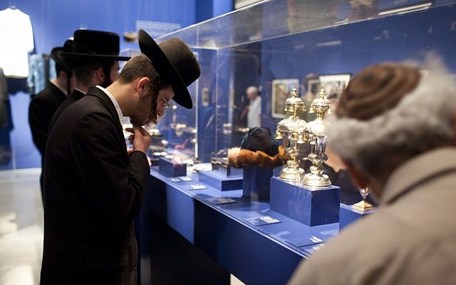 Visitors looking at photographs displayed at the Israel Museum exhibition "A World Apart Next Door: Glimpses into the life of Hasidic Jews" in Jerusalem on June 20, 2012 (photo credit: Yonatan Sindel/Flash90)