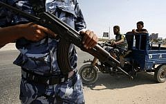 Illustrative photo of a Hamas police officer carrying a rifle in the Gaza Strip (Abed Rahim Khatib/Flash90)