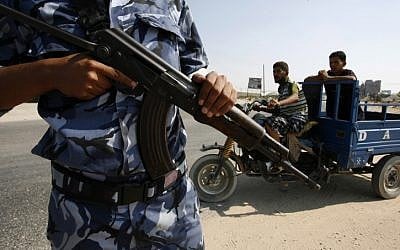 Illustrative photo of a Hamas police officer carrying a rifle in the Gaza Strip (Abed Rahim Khatib/Flash90)
