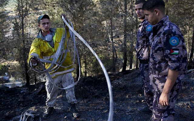 Palestinian and Israeli firefighters fight a blaze in the Jerusalem mountains on Saturday (photo credit: Yonatan Sindel/Flash90)