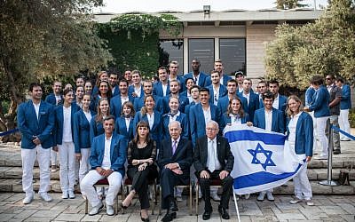 President Shimon Peres with the Israeli Olympic team on July 9. In an agreement with British authorities, Shin Bet bodyguards will travel with the team. (photo credit: Noam Moskowitz/Flash90)