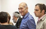 Former prime minister Ehud Olmert grins in the courtroom during his corruption trial. (photo credit: Emil Salman/Flash90)